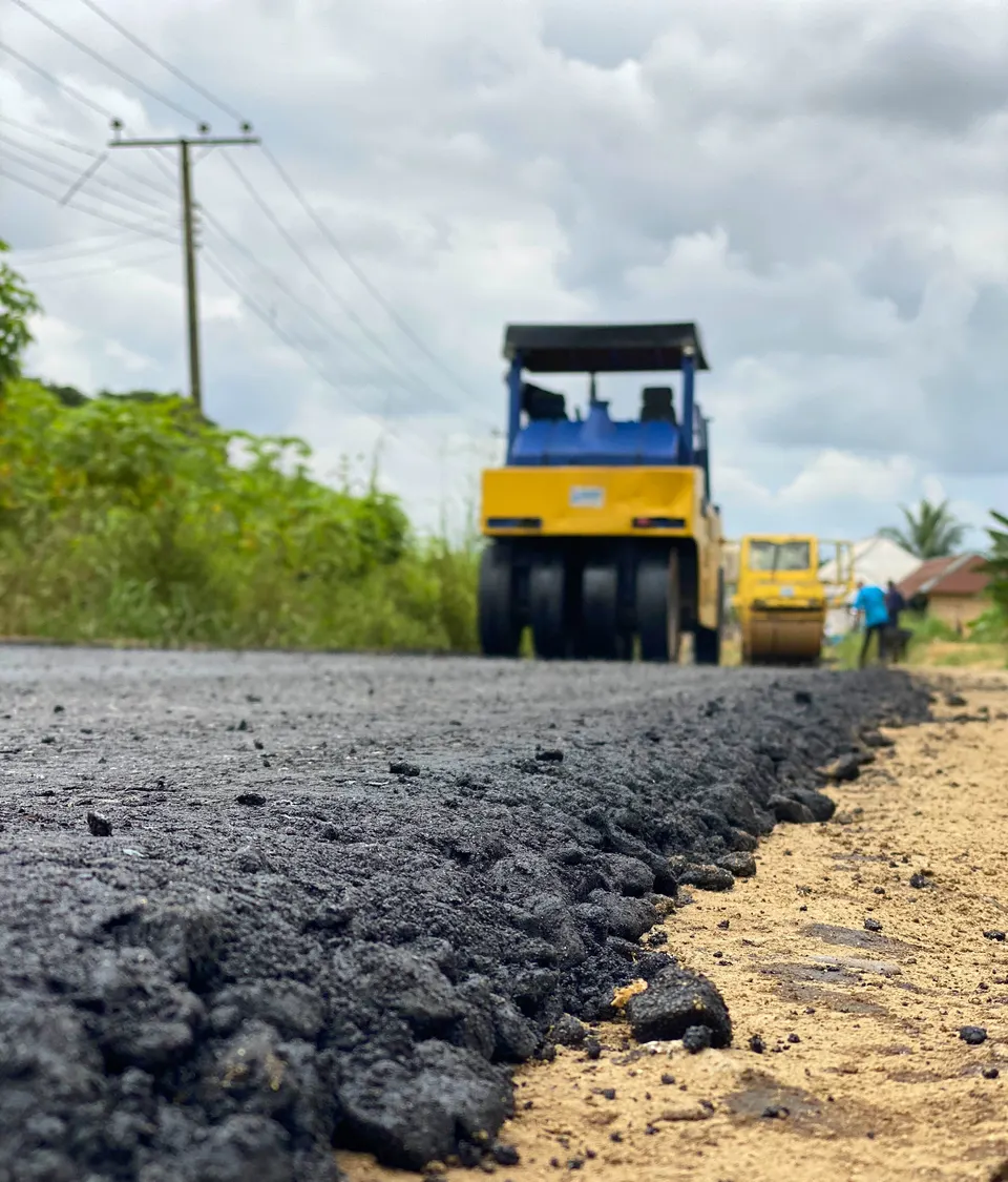 Road roller approaching over freshly laid construction material