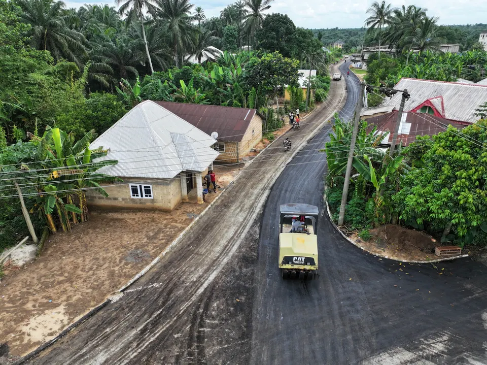 Aerial view of a newly surfaced road running through a community