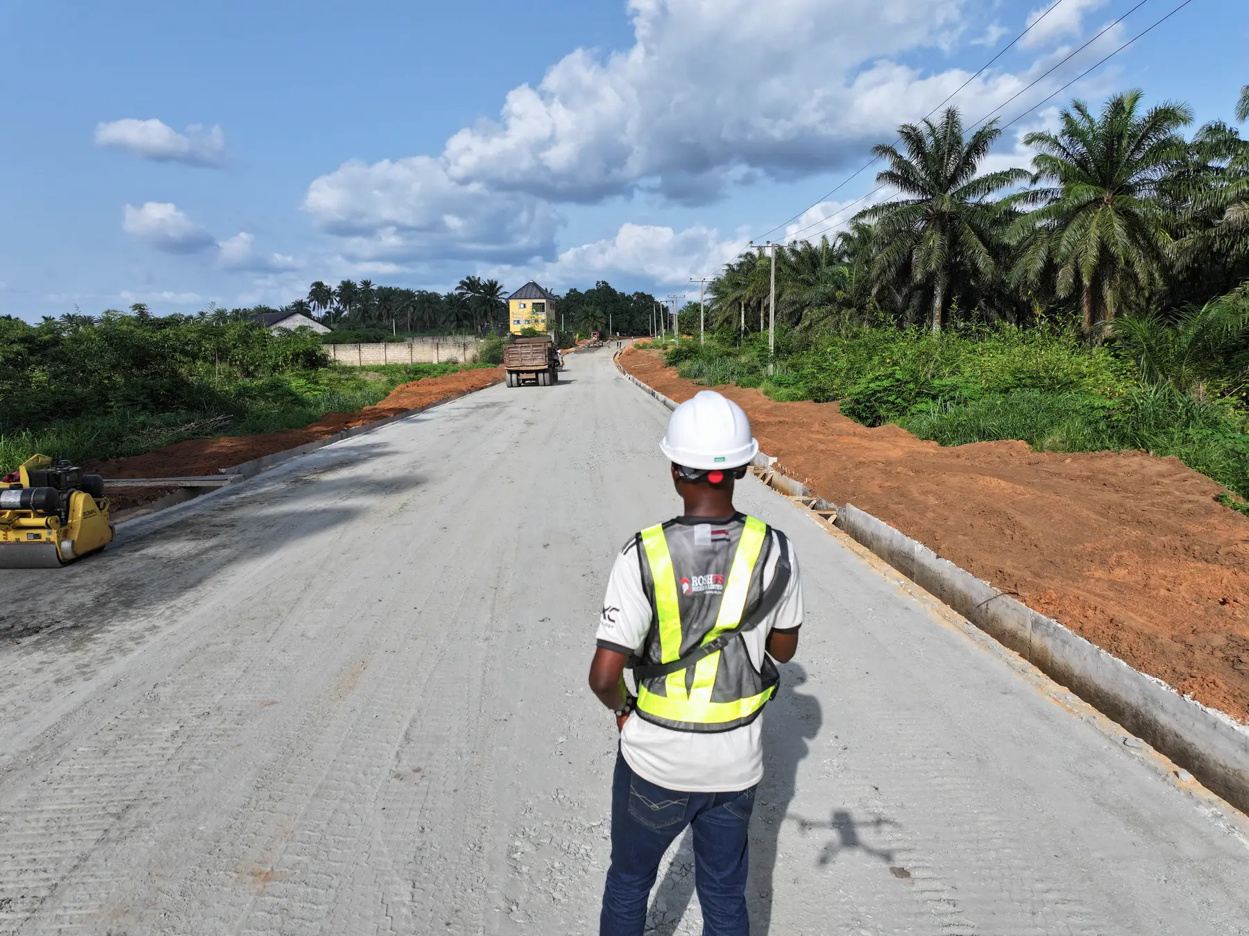 The same road corridor after drainage edges and a prepared base were completed